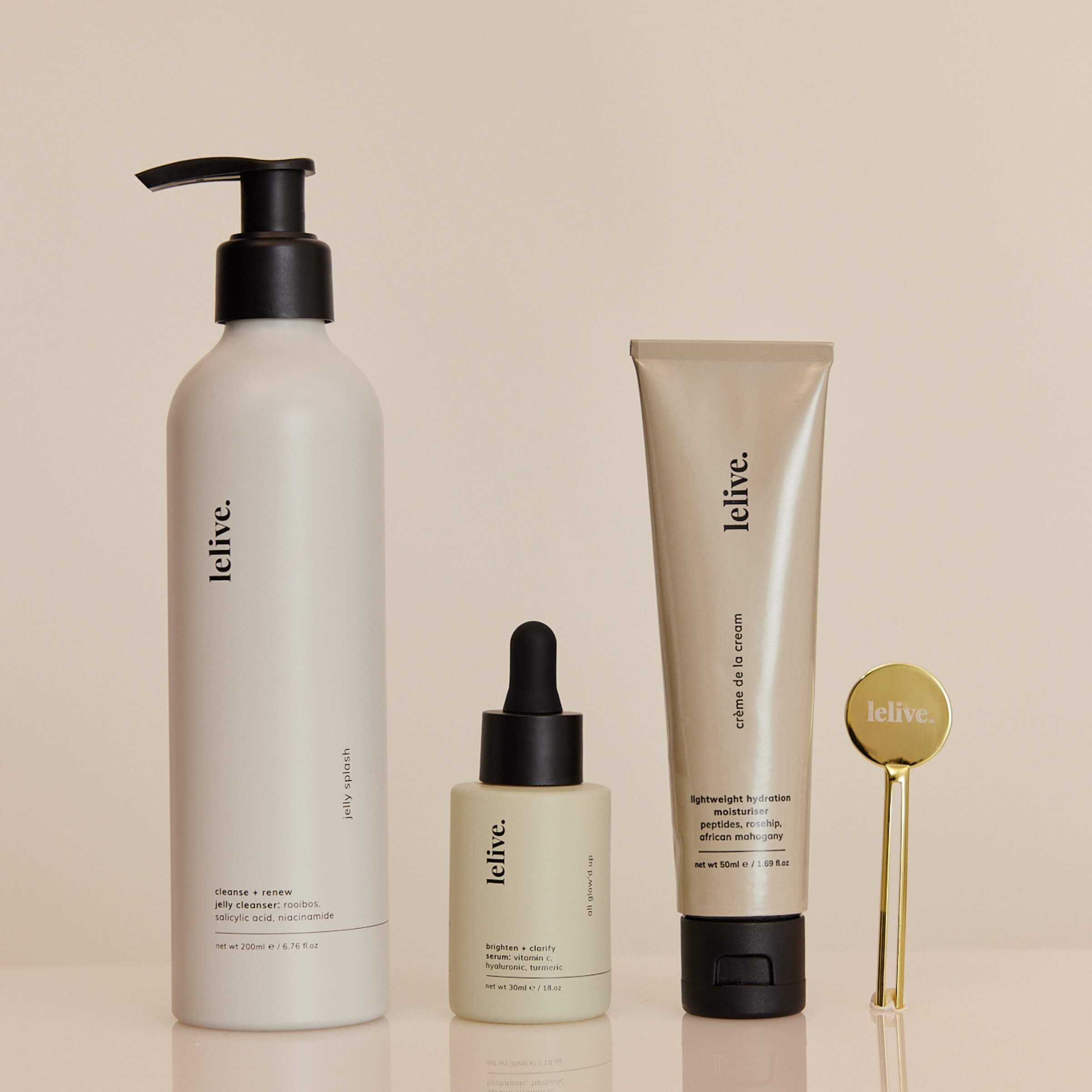 A collection of three skincare products from lelive. a jelly cleanser, brightening serum and peptide moisturiser including a tube key roller.